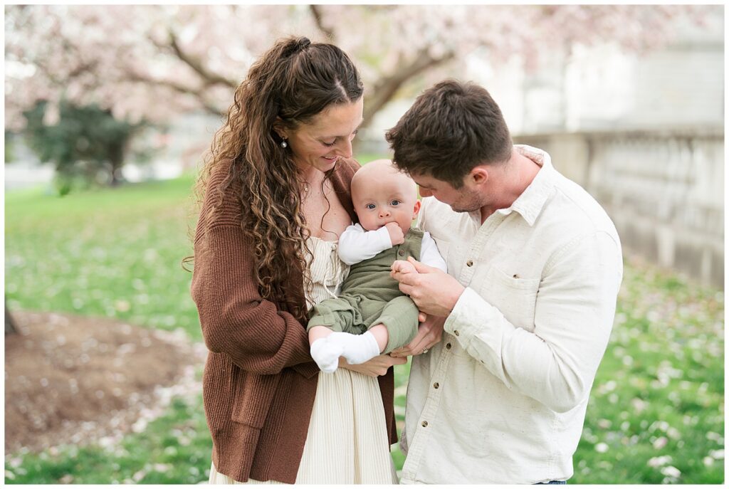 family smiling at baby
