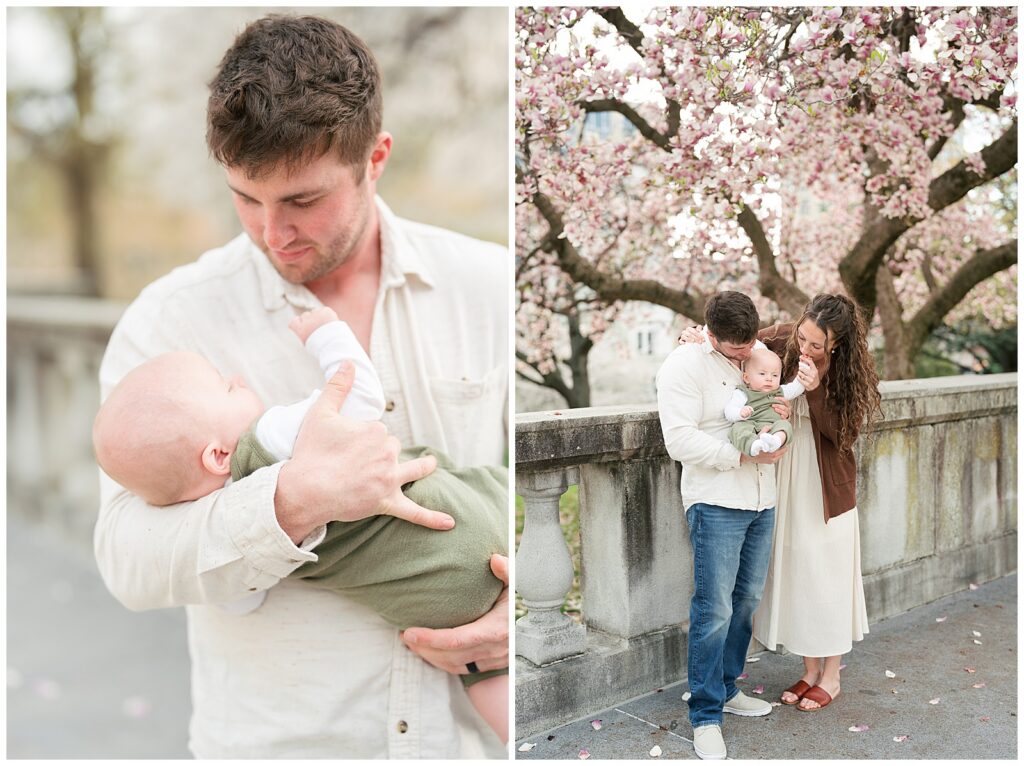 father cradling baby son and family posed under magnolia tree