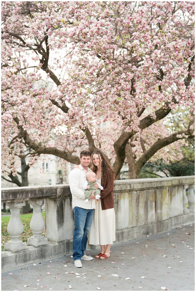 family under magnolia blossom tree
