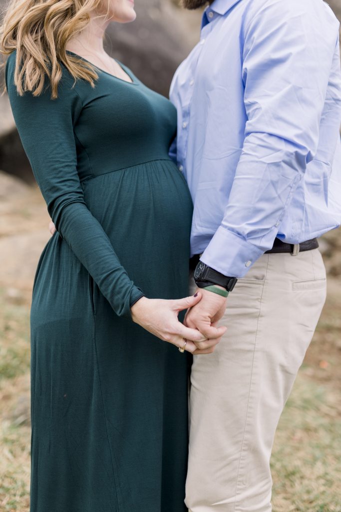 Hands and lower body shot to showcase pregnant belly