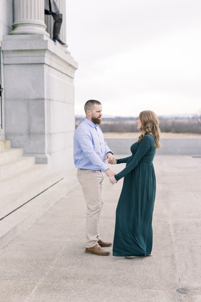 Couple holding hands on marble steps 
