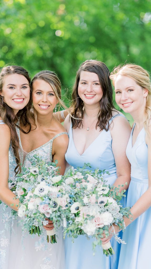 bridesmaids leaning towards camera smiling