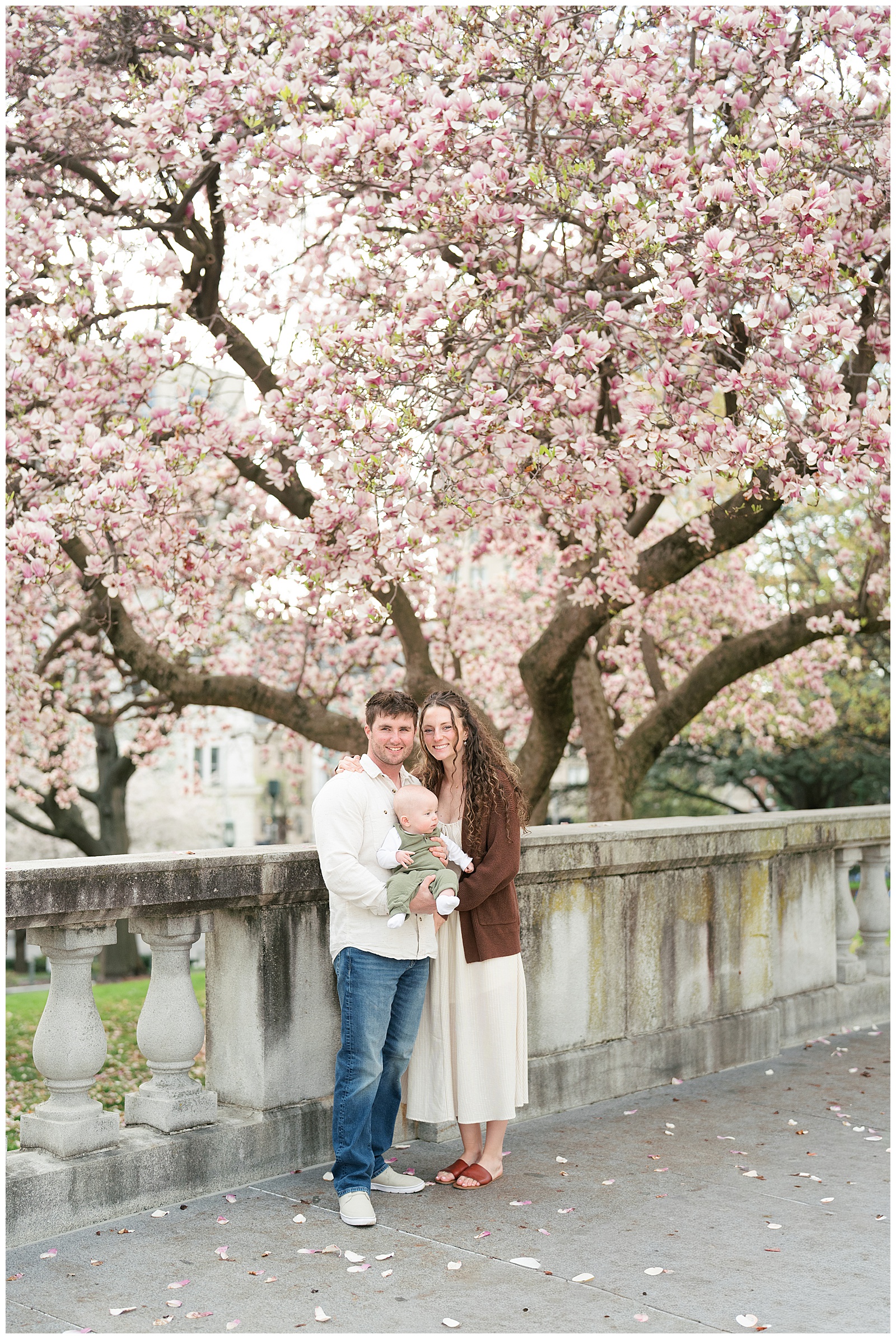 family under magnolia blossom tree